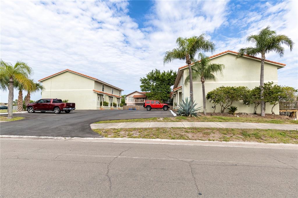 6504 Abaco Drive, Unit 101 Apollo Beach, FL 33572 - Photo 5 of 34 a view of a house with a yard and coconut trees