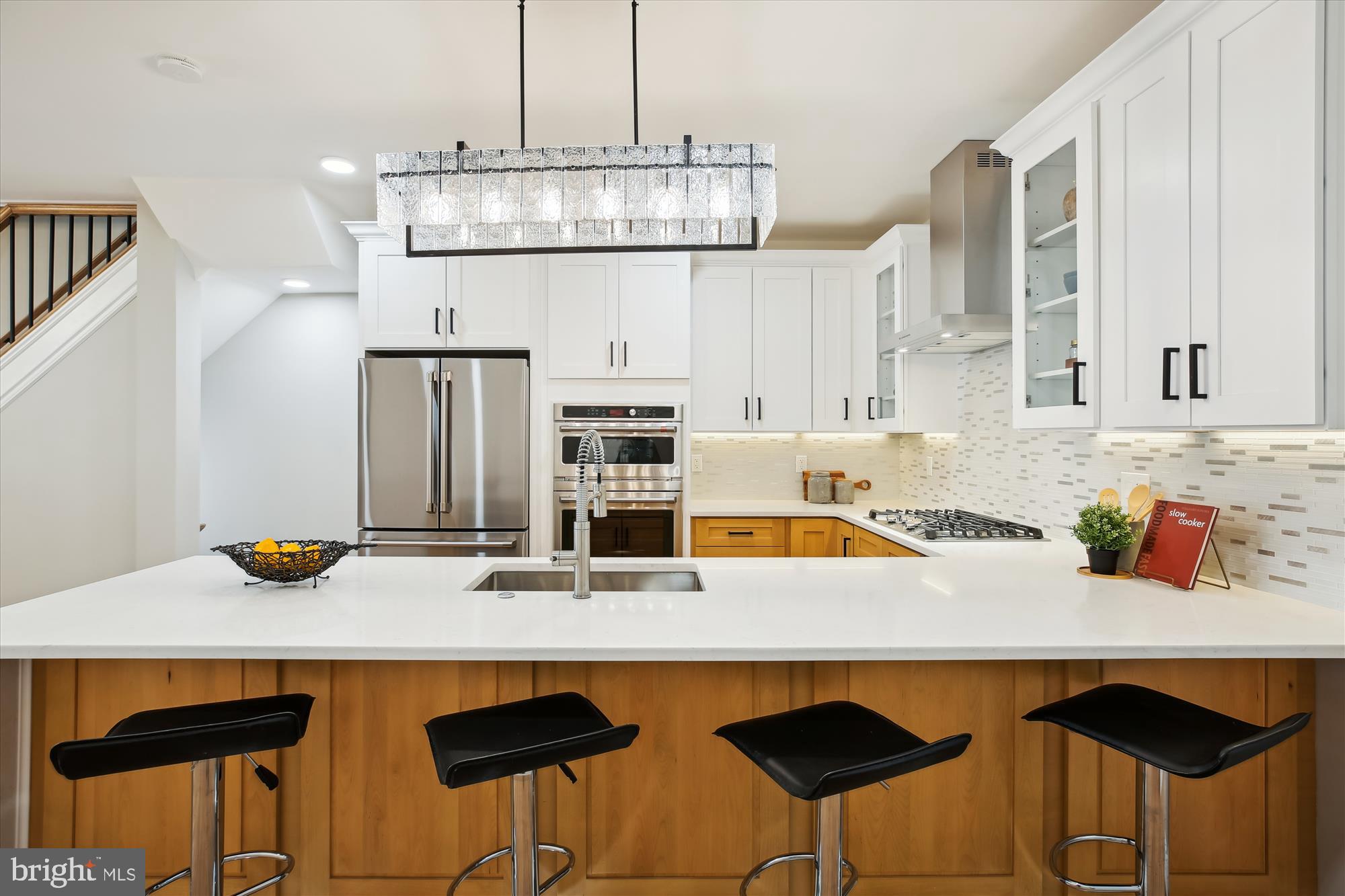 329 15th Street Northeast Washington, DC 20002 - Photo 11 of 71 a kitchen with stainless steel appliances a dining table chairs and white cabinets