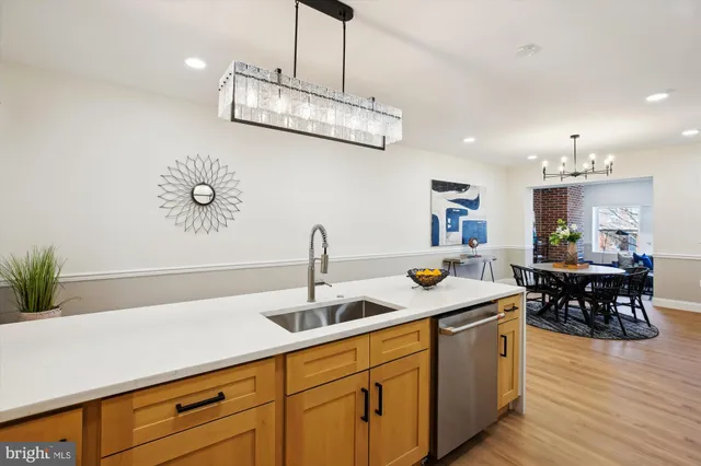 a kitchen with a sink a counter and stainless steel appliances