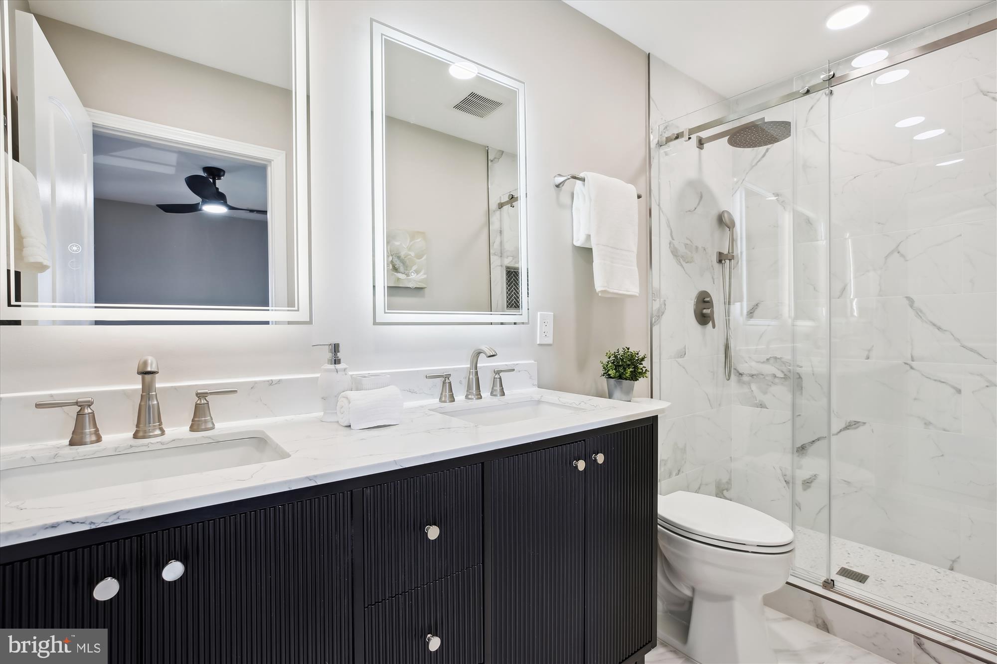 329 15th Street Northeast Washington, DC 20002 - Photo 28 of 71 a bathroom with a double vanity sink toilet and shower
