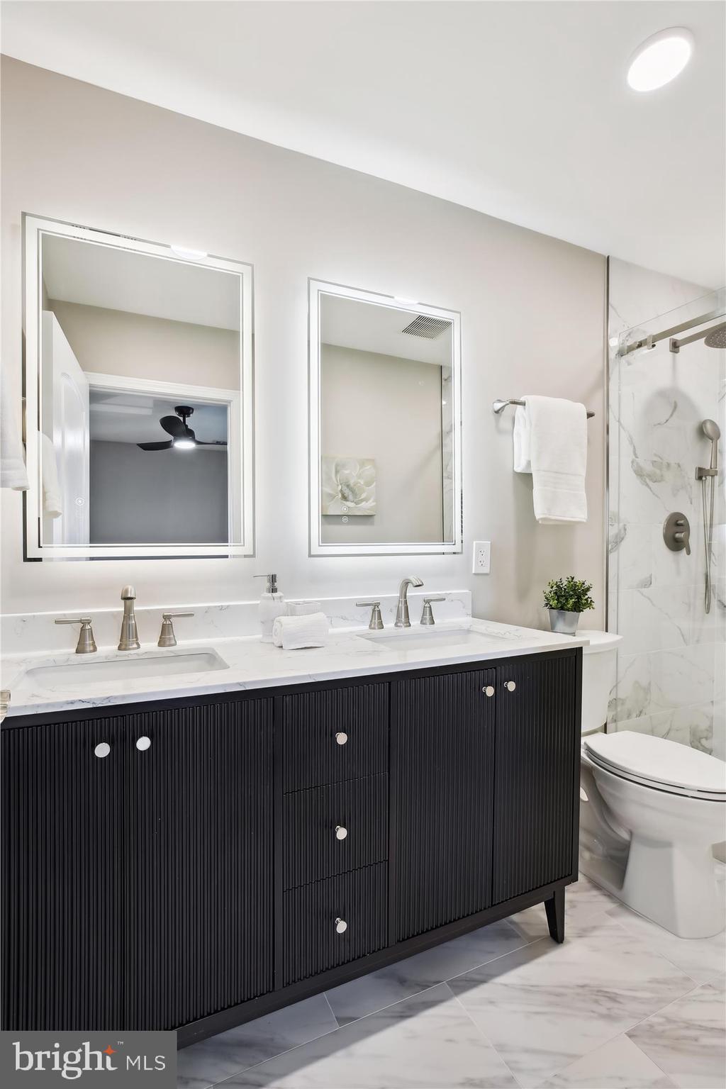 329 15th Street Northeast Washington, DC 20002 - Photo 29 of 71 a bathroom with a double vanity sink and mirror with toilet
