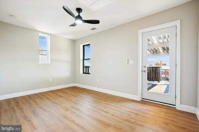 a view of an empty room with wooden floor