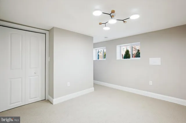 a view of a hallway with a livingroom and a bathroom