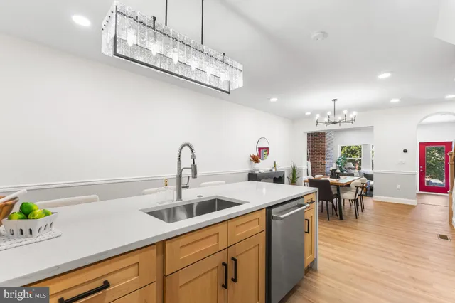 a kitchen with a sink a stove and chairs