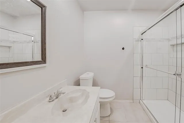 a white toilet sitting next to a bathroom sink