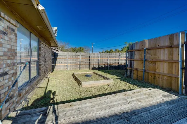a view of a balcony with wooden floor and fence