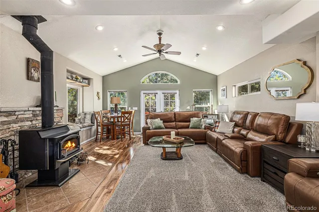 a living room with furniture a fireplace and a chandelier