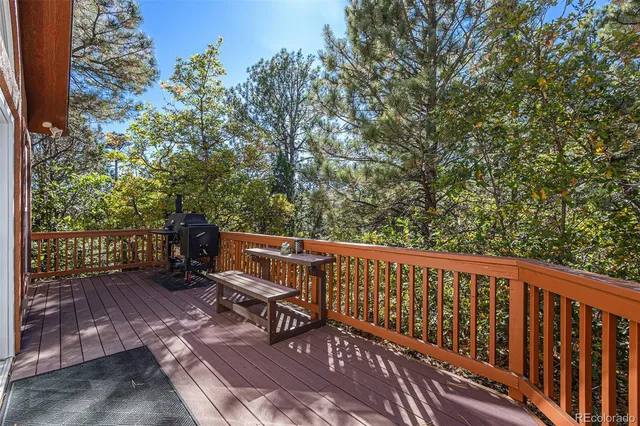 a view of a wooden bench with chairs and a yard