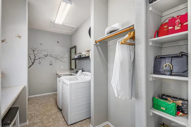 a utility room with closet a washer and dryer