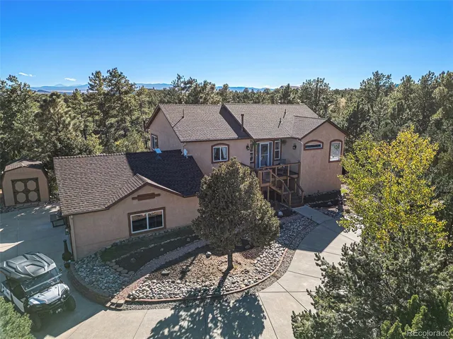 aerial view of a house with a yard