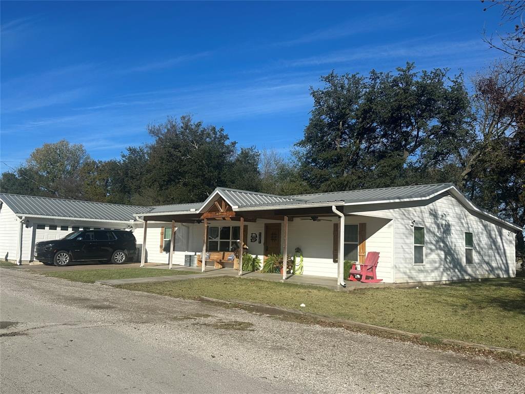 101 Twin Creek Road Comanche, TX 76442 - Photo 4 of 28 Single story home featuring a porch, a metal roof, and a front yard