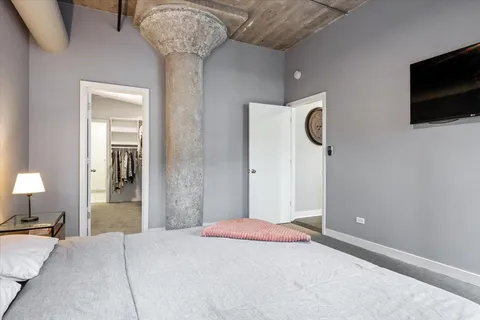 a bedroom with a bed and a chandelier