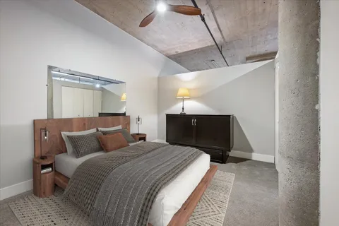 a bedroom with a bed and a mirror