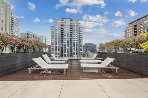 a view of a patio with a table and chairs and potted plants