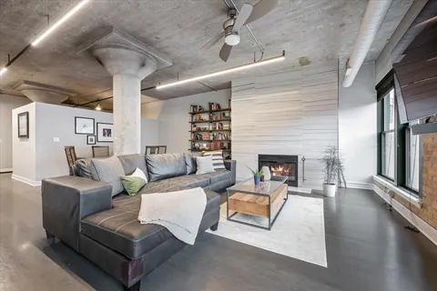 a living room with furniture and a fireplace