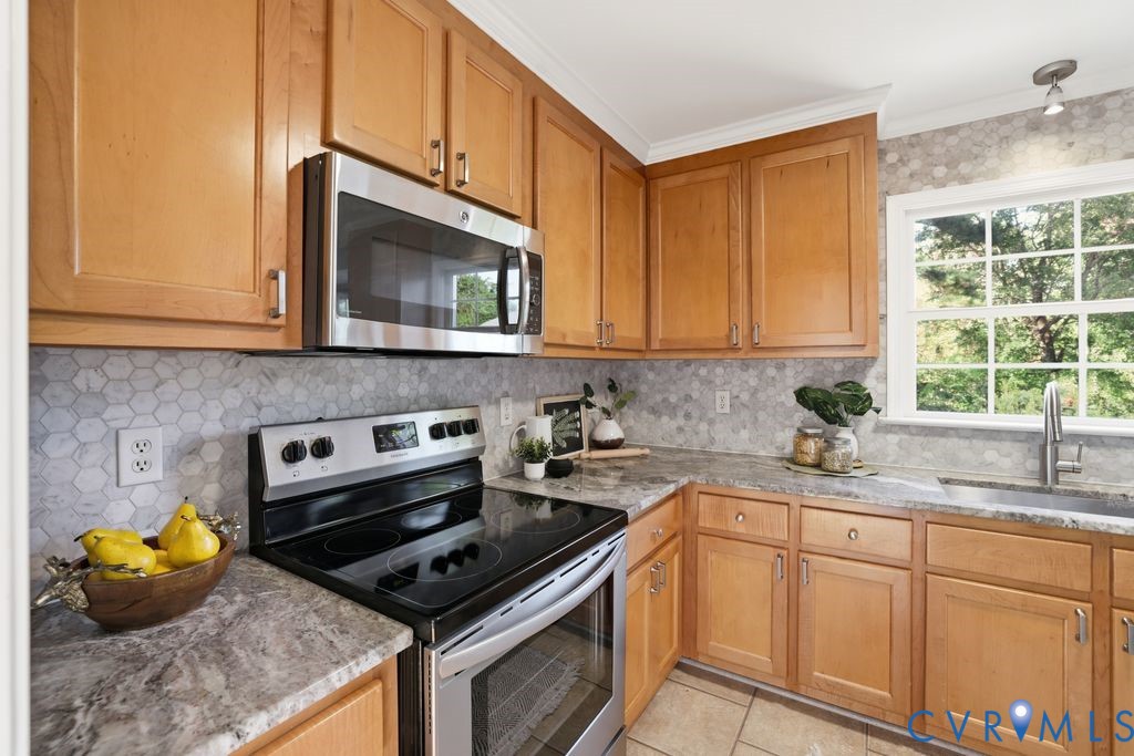 12004 Stamford Road Midlothian, VA 23112 - Photo 13 of 49 a kitchen with stainless steel appliances a stove a microwave sink and cabinets