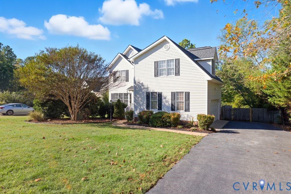 12004 Stamford Road Midlothian, VA 23112 - Photo 2 of 49 a front view of a house with a yard and garage
