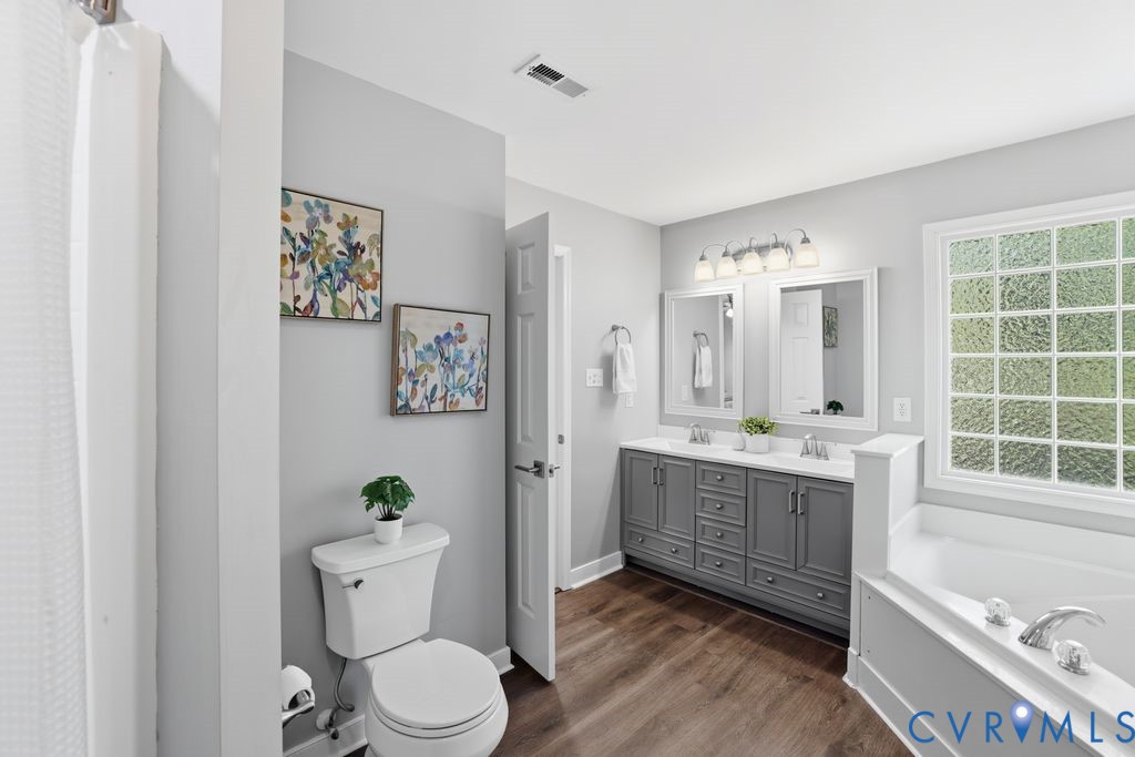 12004 Stamford Road Midlothian, VA 23112 - Photo 30 of 49 a spacious bathroom with a granite countertop toilet a sink and a bathtub
