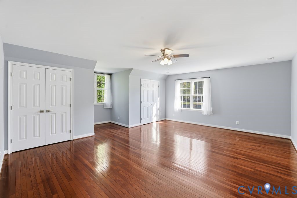 12004 Stamford Road Midlothian, VA 23112 - Photo 32 of 49 a view of an empty room with wooden floor and a window