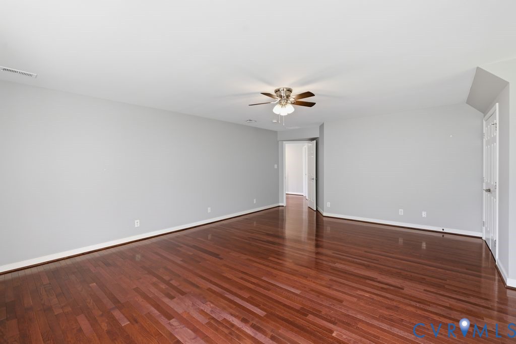 12004 Stamford Road Midlothian, VA 23112 - Photo 33 of 49 a view of an empty room with wooden floor and a window