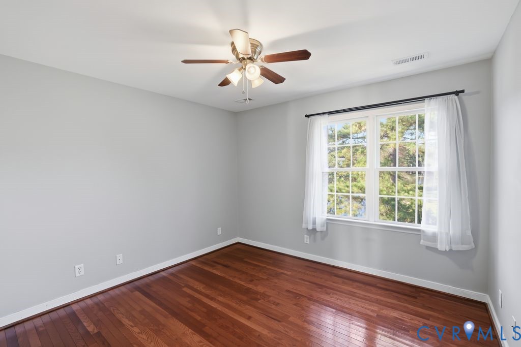 12004 Stamford Road Midlothian, VA 23112 - Photo 34 of 49 an empty room with wooden floor and windows