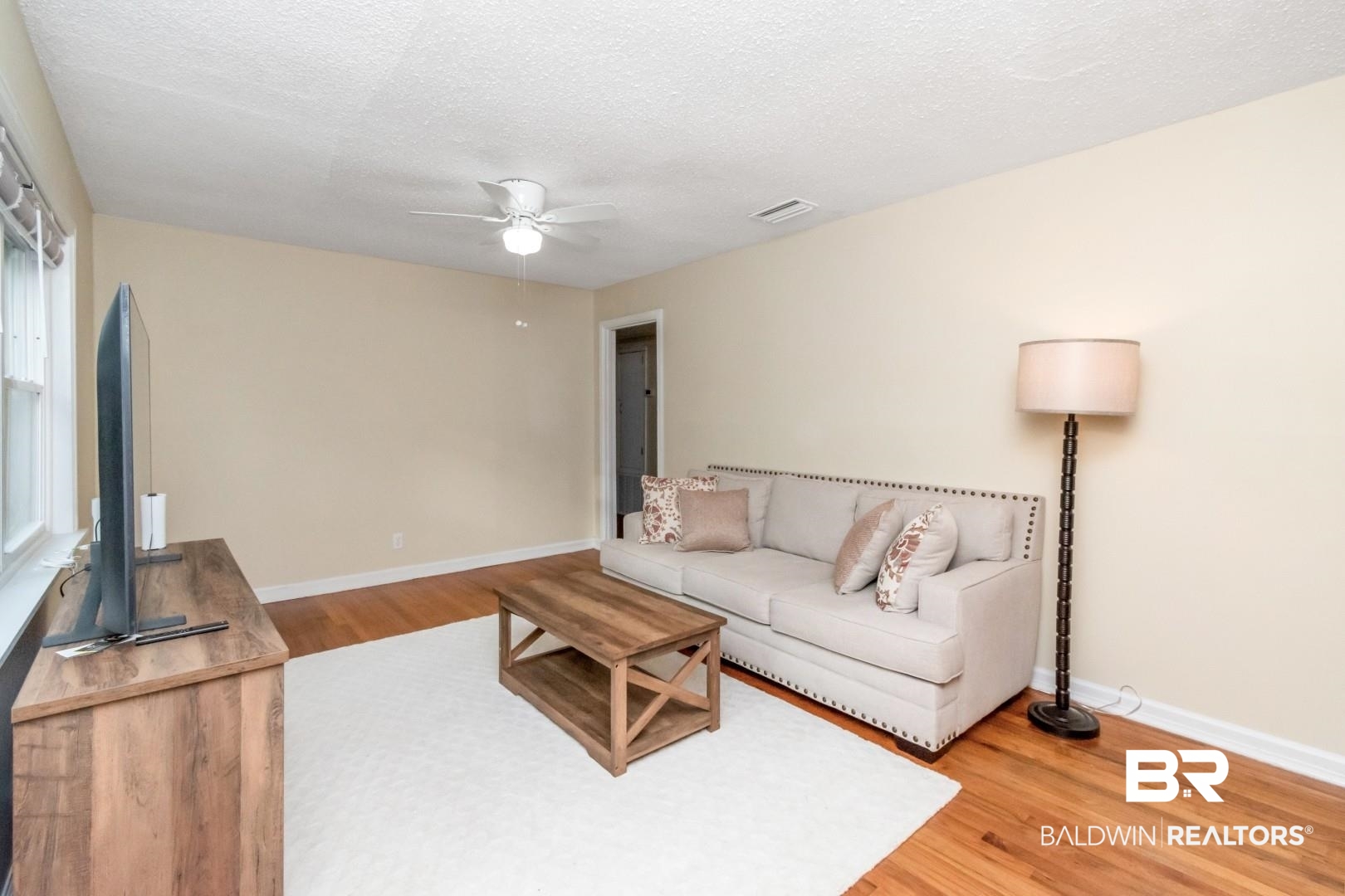 61 Nack Lane Mobile, AL 36608 - Photo 7 of 25 Living room with ceiling fan, hardwood / wood-style flooring, and a textured ceiling
