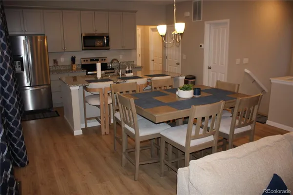 a view of a dining room with furniture and wooden floor