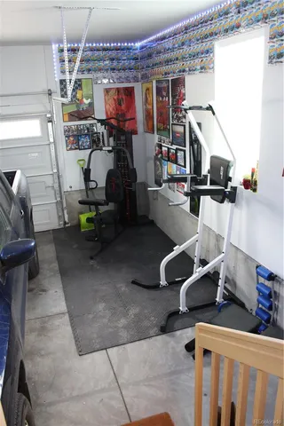 a living room with furniture and a view of kitchen