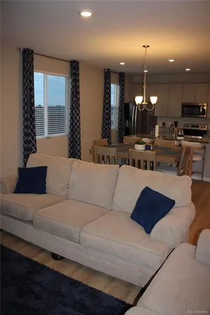 a kitchen with a table chairs and a wooden floor
