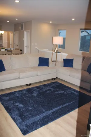 a living room with kitchen view and a couch