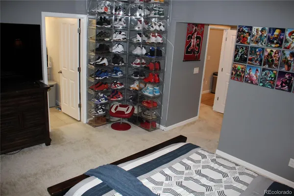 walk in closet with clothes and shoes