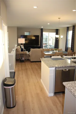 a kitchen with kitchen island a stove a sink and a refrigerator
