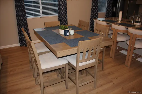 a view of a dining room with furniture and wooden floor