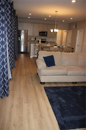a view of kitchen with kitchen island a sink stainless steel appliances and cabinets