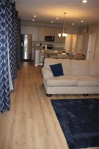 a view of kitchen with kitchen island a sink stainless steel appliances and cabinets