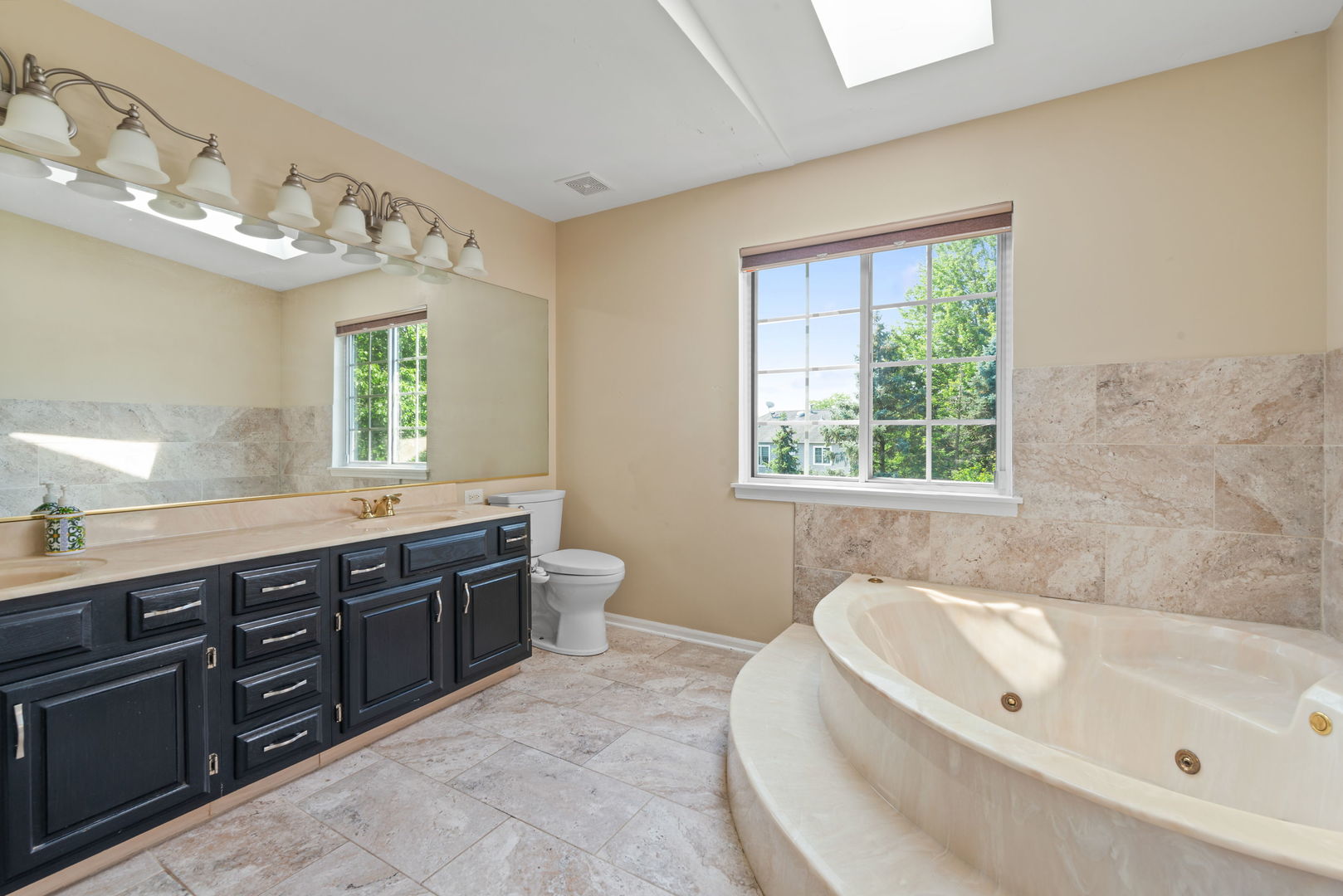 754 Huntington Drive Carol Stream, IL 60188 - Photo 14 of 29 a spacious bathroom with a tub sink and a window