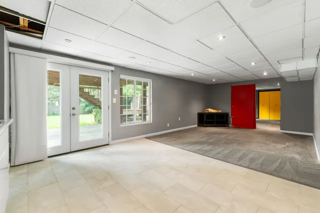 a view of empty room with cabinet and windows