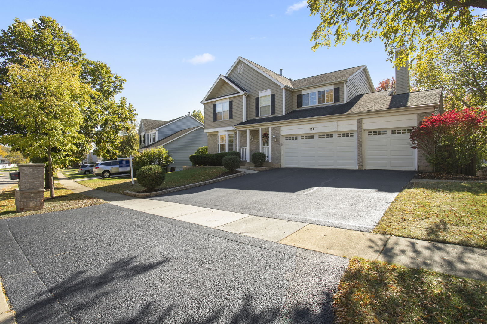 754 Huntington Drive Carol Stream, IL 60188 - Photo 2 of 29 a front view of a house with a garden