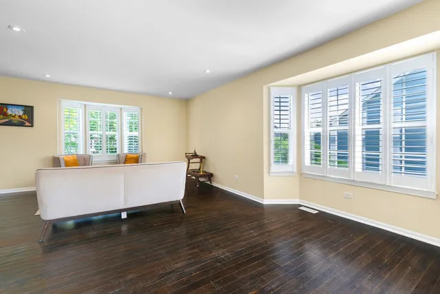 a living room with furniture and large windows
