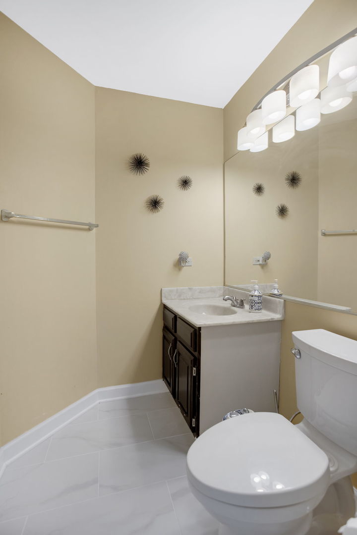 754 Huntington Drive Carol Stream, IL 60188 - Photo 9 of 29 a bathroom with a sink a toilet and shower