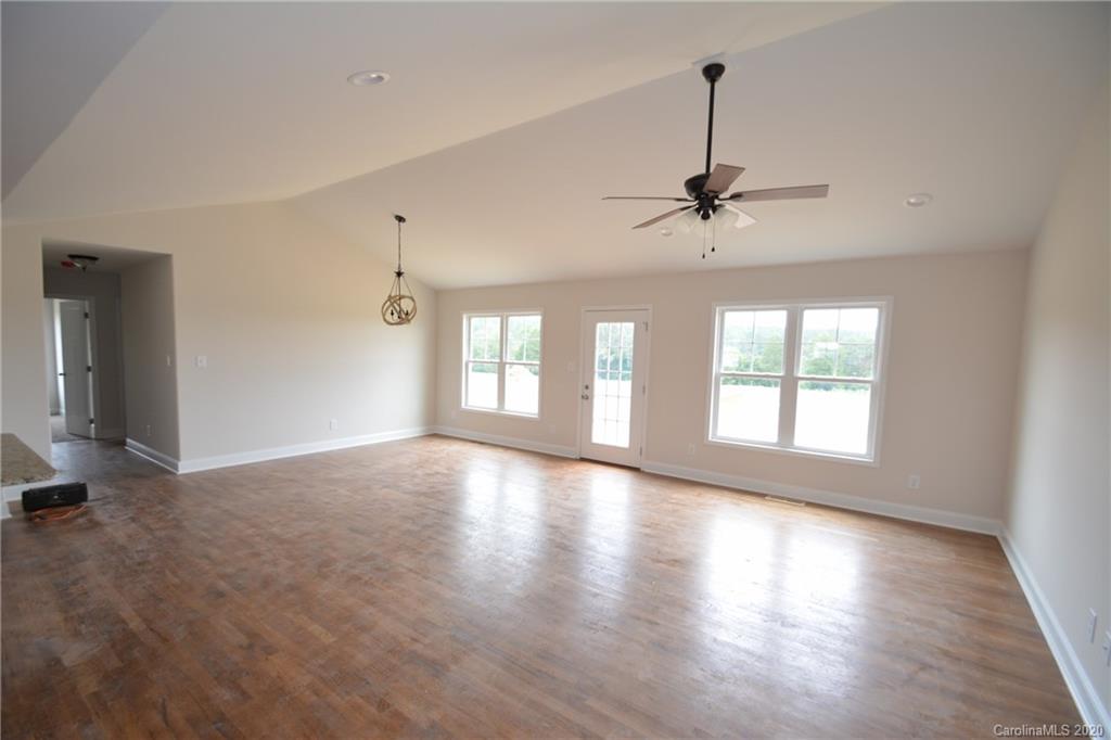 1311 George Brown Road Crouse, NC 28033 - Photo 12 of 32 a view of empty room with wooden floor and fan