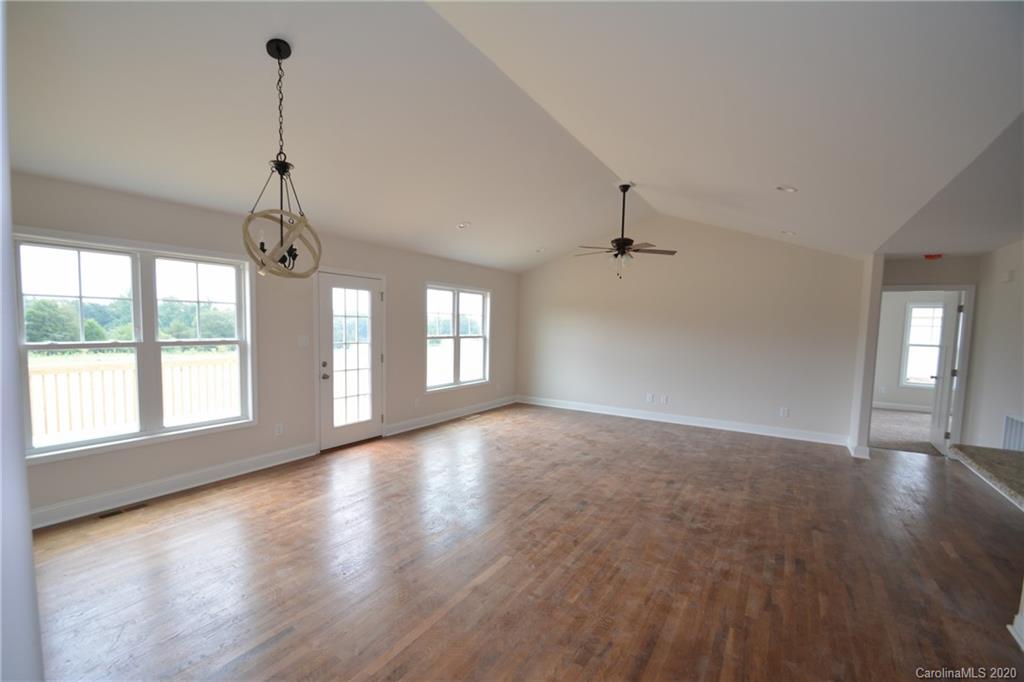 1311 George Brown Road Crouse, NC 28033 - Photo 13 of 32 a view of an empty room with wooden floor and a window