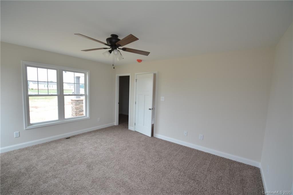 1311 George Brown Road Crouse, NC 28033 - Photo 17 of 32 an empty room with windows and fan