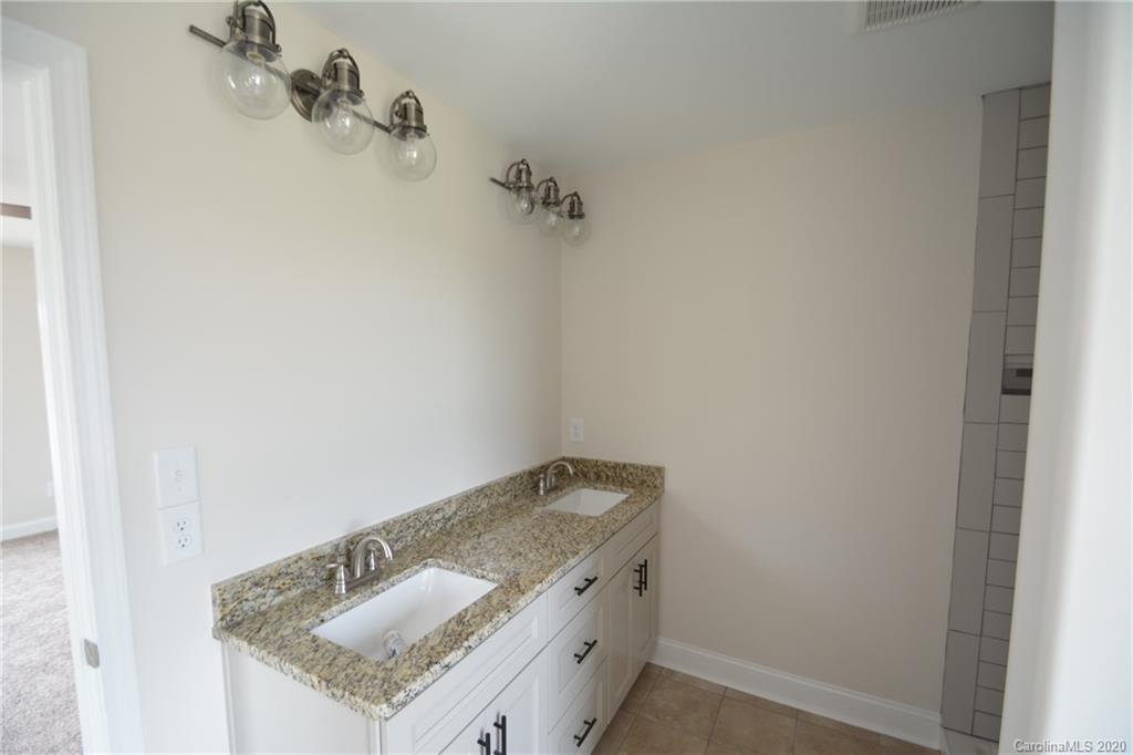 1311 George Brown Road Crouse, NC 28033 - Photo 20 of 32 a bathroom with a granite countertop sink and vanity
