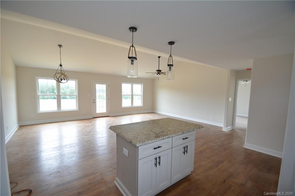 1311 George Brown Road Crouse, NC 28033 - Photo 23 of 32 a view of granite countertop kitchen island a sink dishwasher and a large window with wooden floor