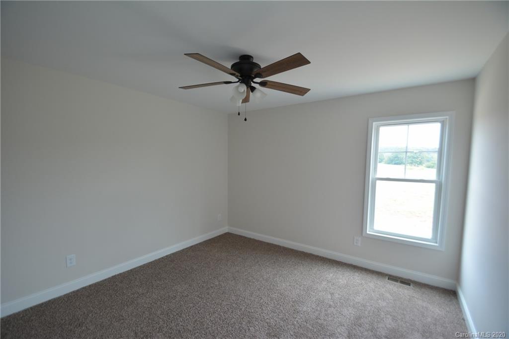 1311 George Brown Road Crouse, NC 28033 - Photo 24 of 32 an empty room with a window and a fan