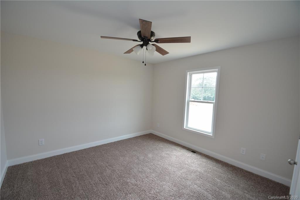1311 George Brown Road Crouse, NC 28033 - Photo 28 of 32 an empty room with a window and a fan