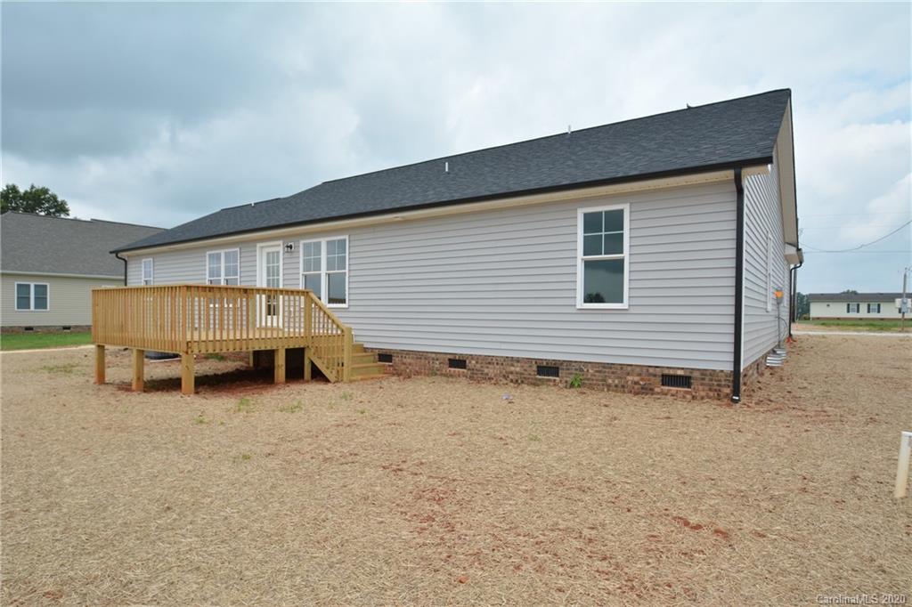 1311 George Brown Road Crouse, NC 28033 - Photo 31 of 32 a backyard of a house with barbeque oven table and chairs