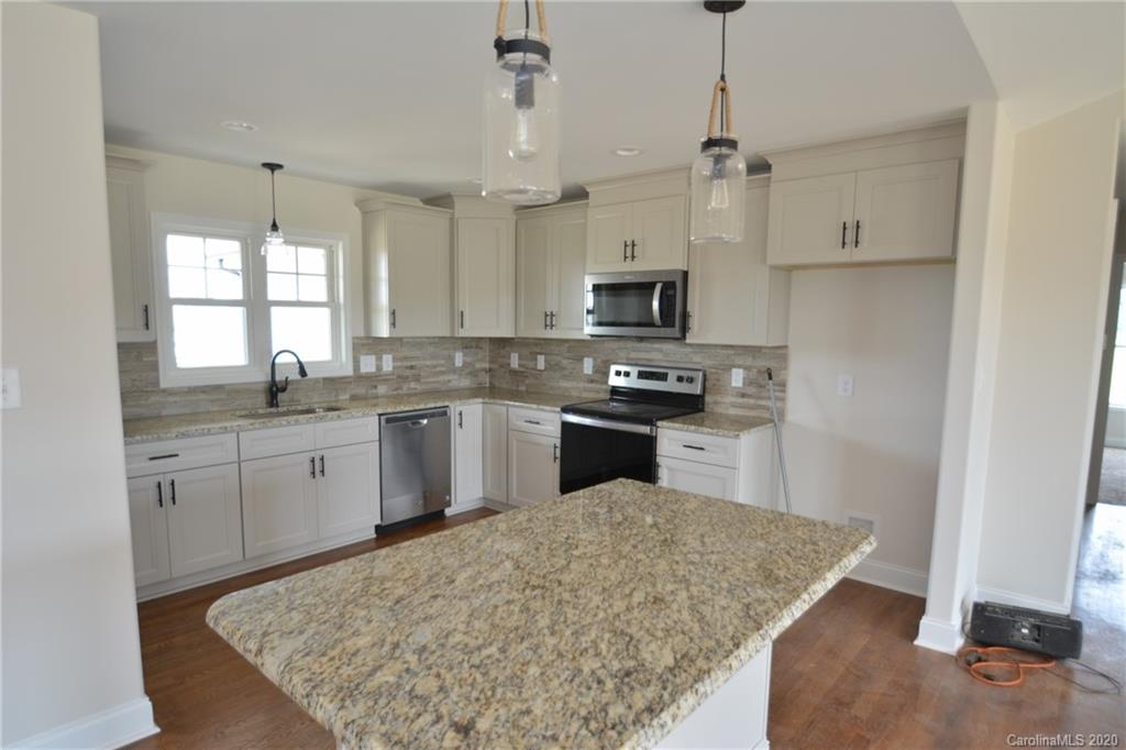 1311 George Brown Road Crouse, NC 28033 - Photo 5 of 32 a kitchen with kitchen island sink stove and refrigerator