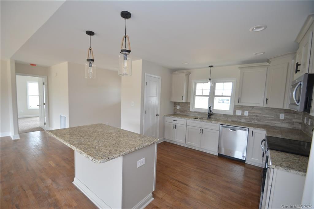 1311 George Brown Road Crouse, NC 28033 - Photo 6 of 32 a kitchen with stainless steel appliances granite countertop hardwood floor sink stove and granite counter top